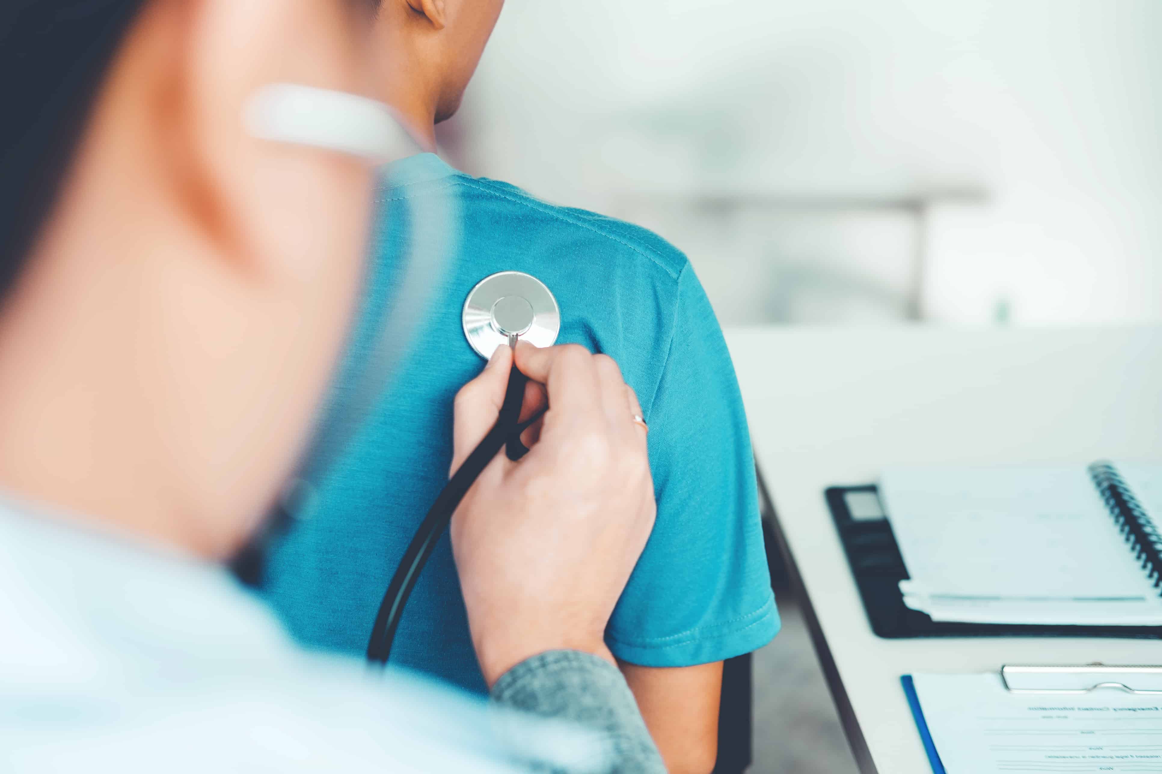 Doctor listening to patients breathing sound with Stethoscope