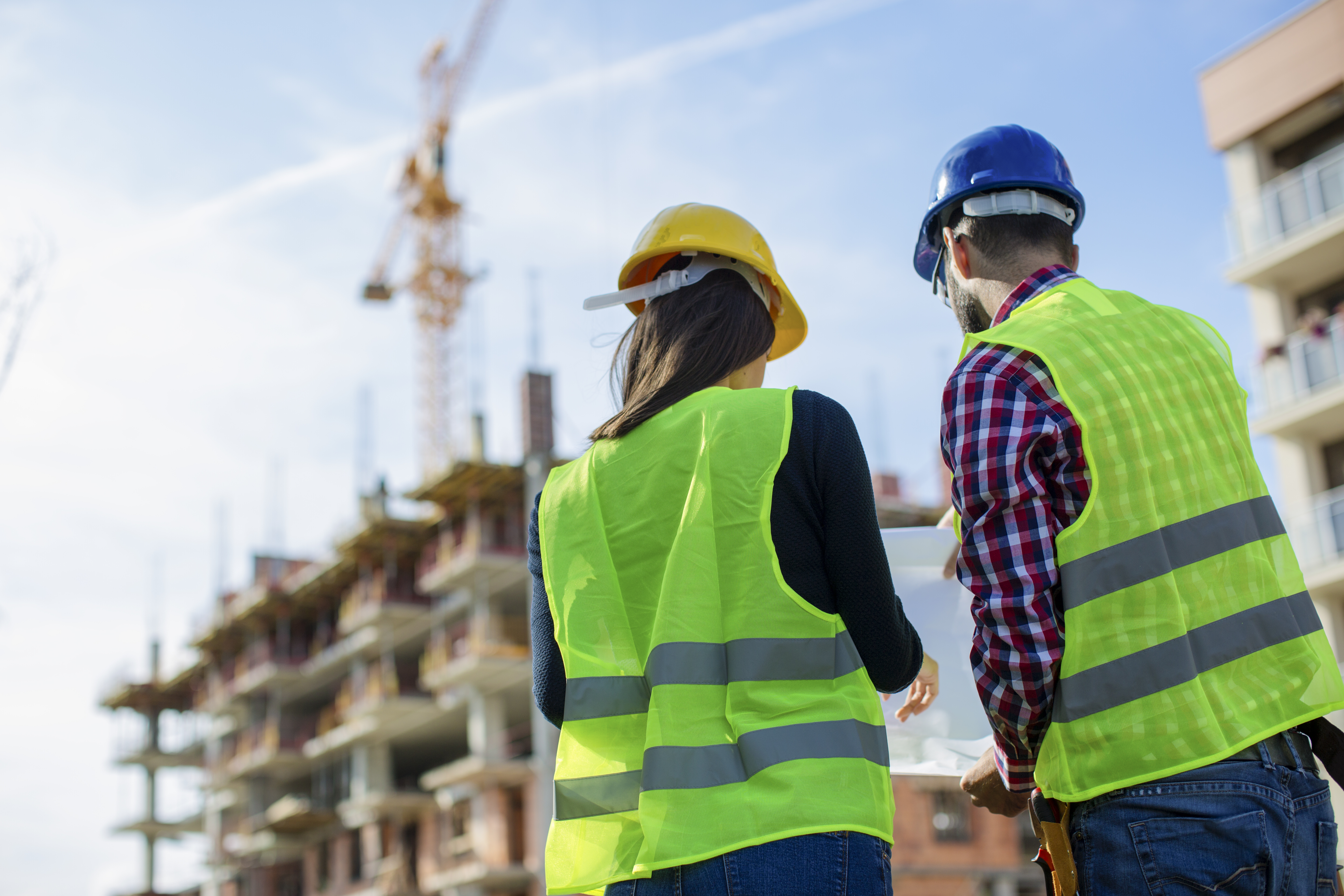 Construction worker and his manager checking the progress